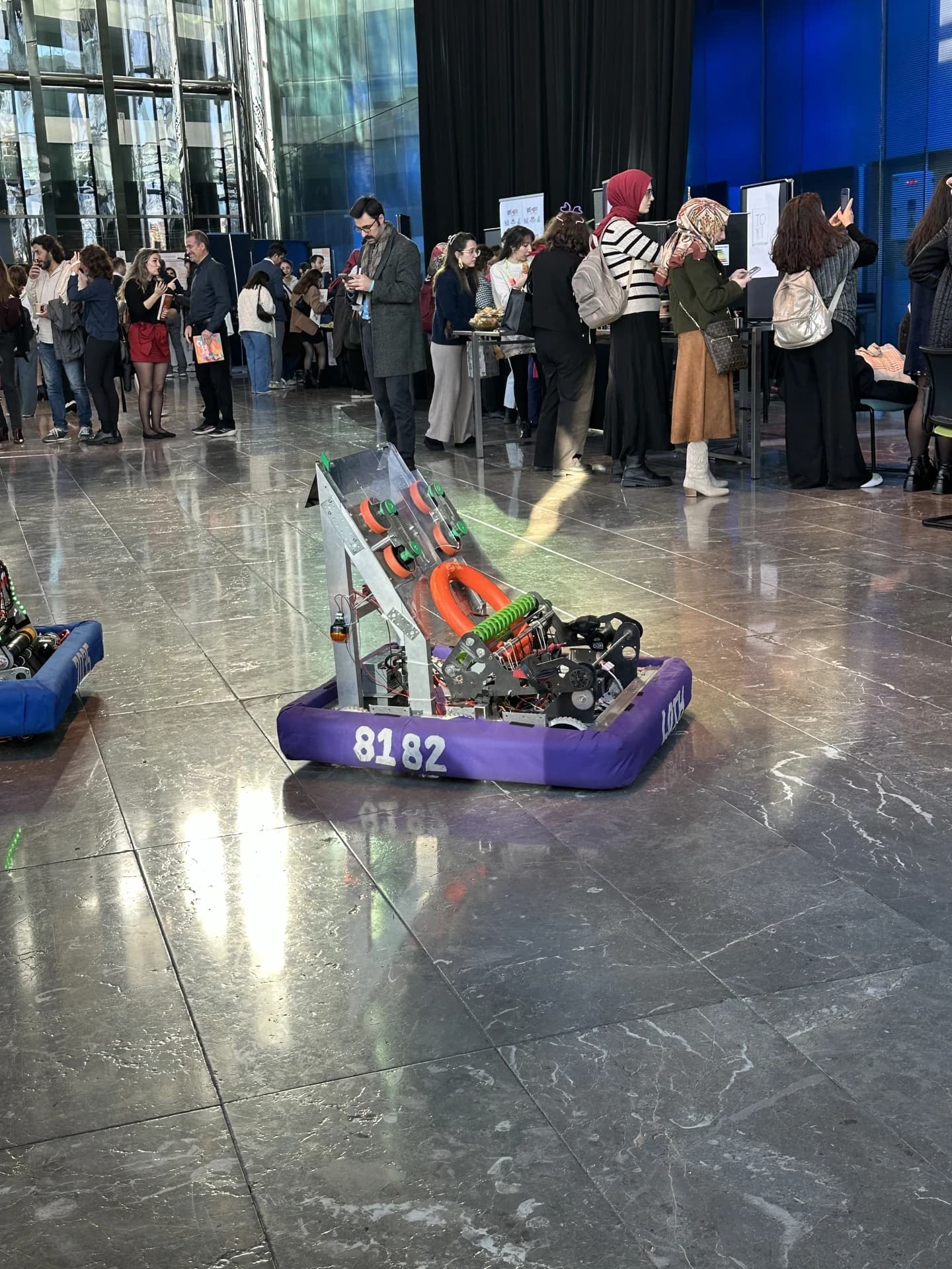 Competitive robotics team working beside a competition field